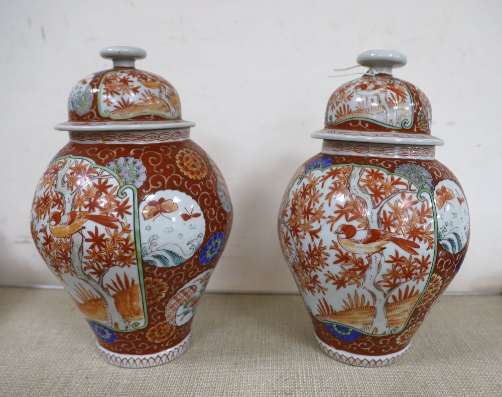 A near pair of Japanese porcelain lidded vases together with a blue and white vase and a dish